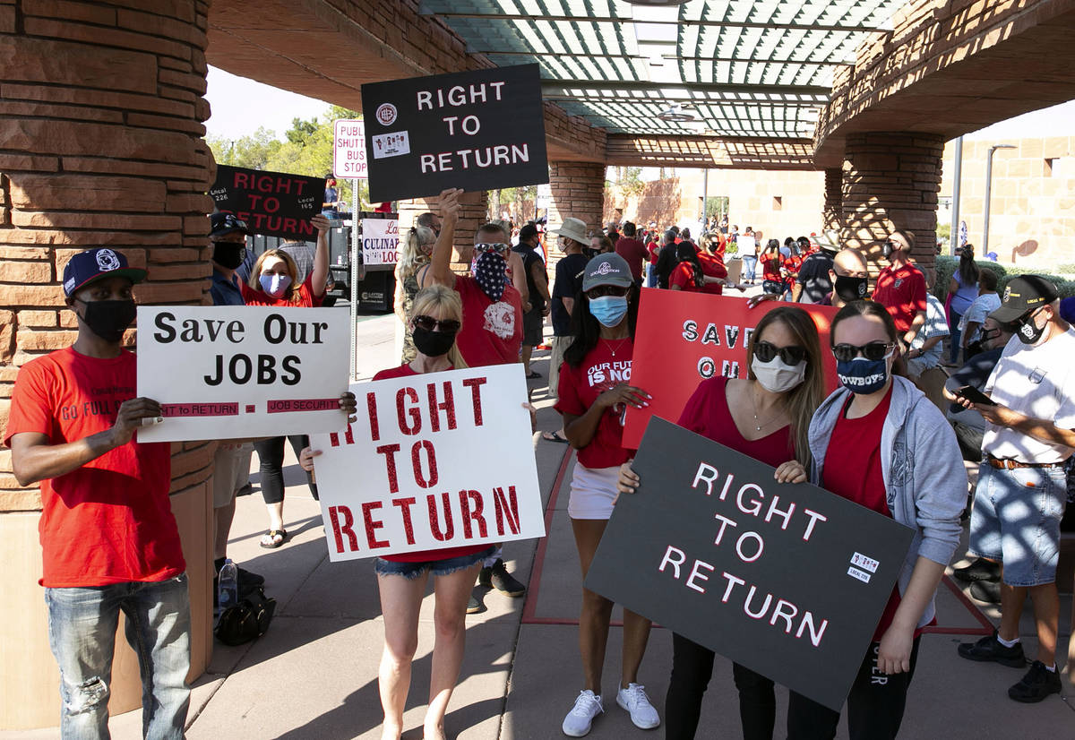 Union members, including Larry Williams, left, and Janine Granito, second right, rally outside ...