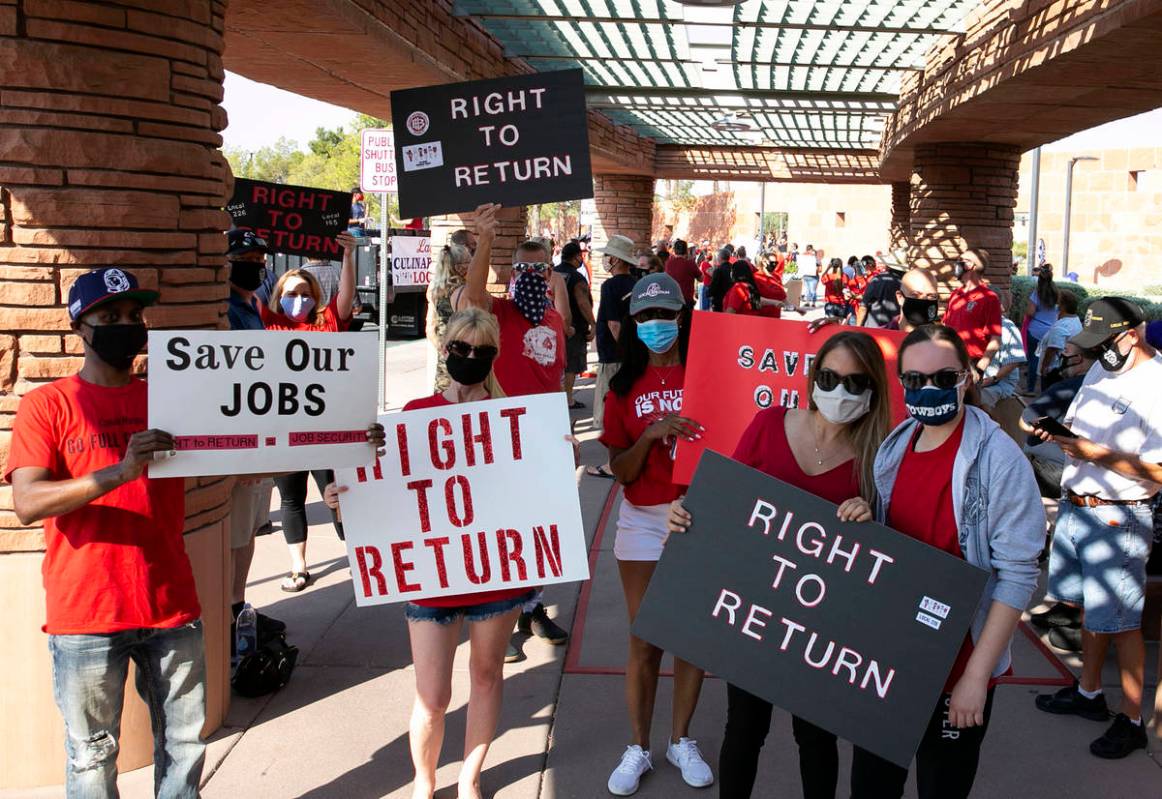 Union members, including Larry Williams, left, and Janine Granito, second right, rally outside ...