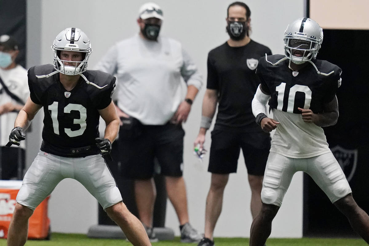 Las Vegas Raiders wide receiver Hunter Renfrow (13) and wide receiver Rico Gafford (10) warm up ...