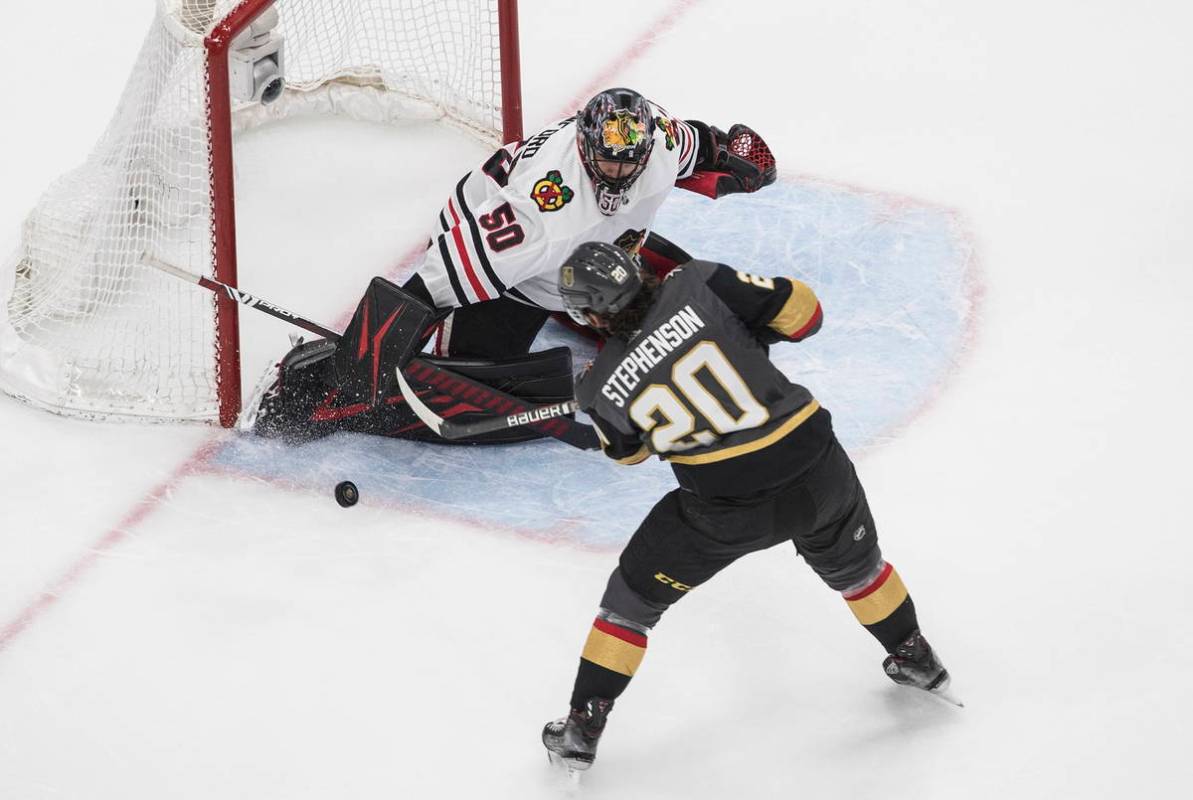 Vegas Golden Knights' Chandler Stephenson (20) is stopped by Chicago Blackhawks goalie Corey Cr ...