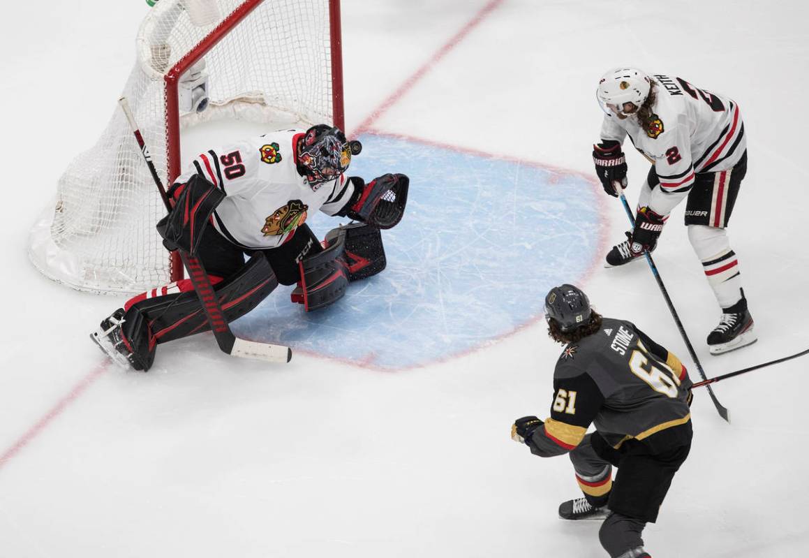 Vegas Golden Knights' Mark Stone (61) scores on Chicago Blackhawks goalie Corey Crawford (50) a ...