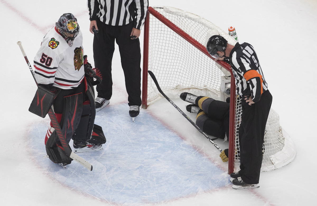 Vegas Golden Knights' Jonathan Marchessault (81) is in the net as Chicago Blackhawks goalie Cor ...