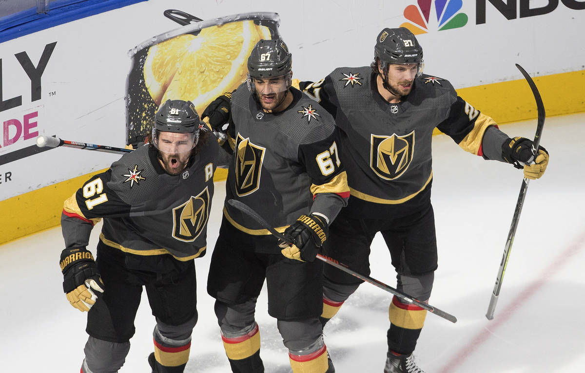 Vegas Golden Knights' Mark Stone (61), Max Pacioretty (67) and Shea Theodore (27) celebrate a g ...