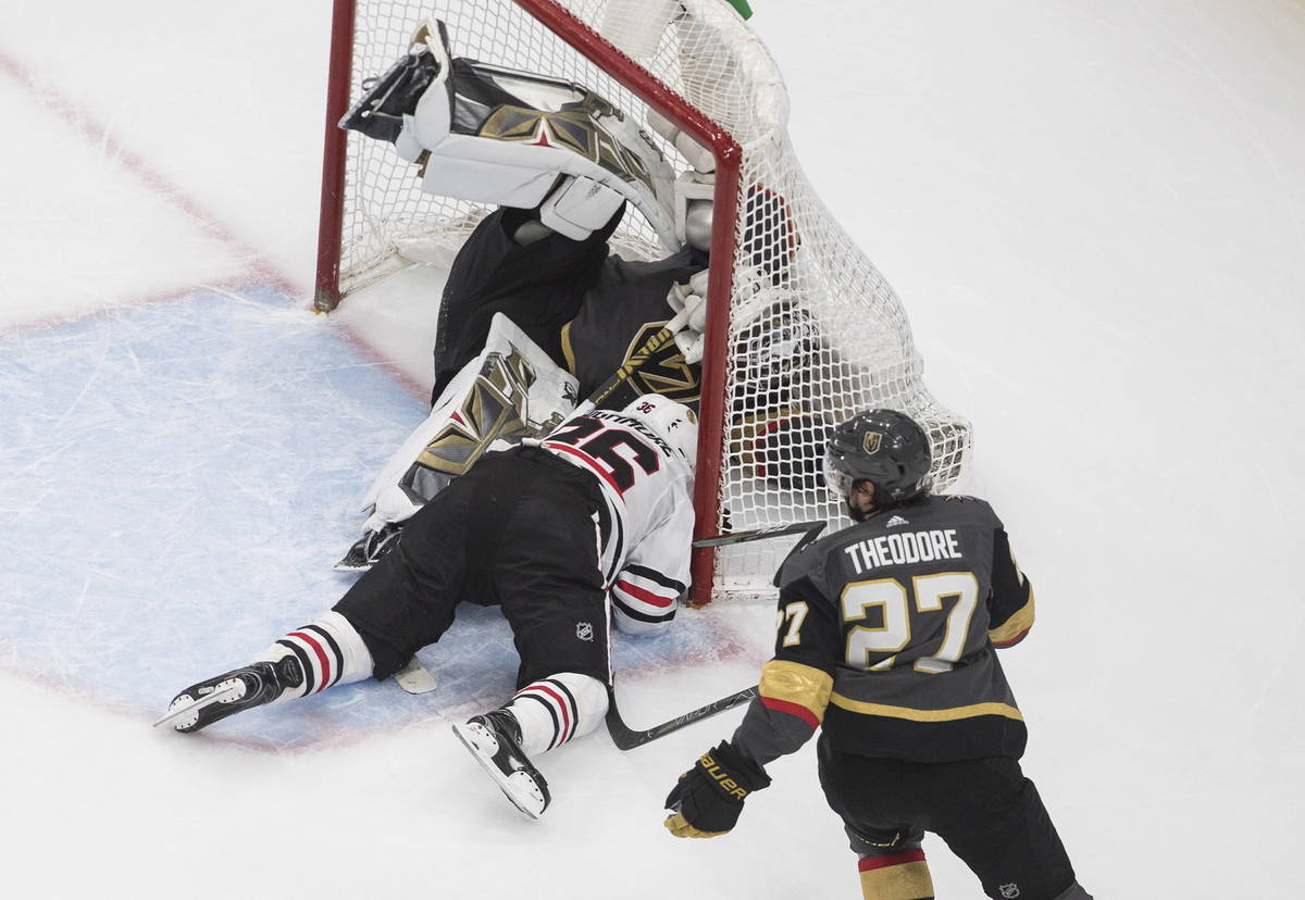 Chicago Blackhawks' Robin Lehner (16) crashes against Vegas Golden Knights goalie Robin Lehner ...