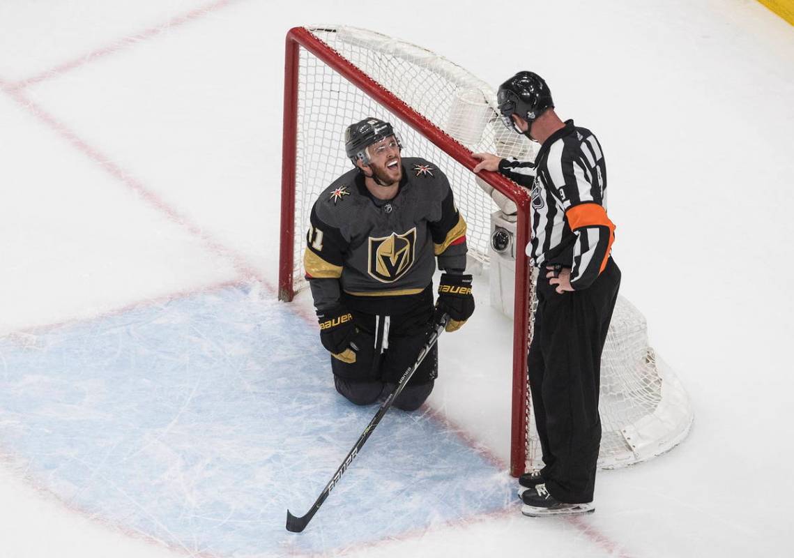 Vegas Golden Knights' Jonathan Marchessault talks with an official after crashing into the net ...