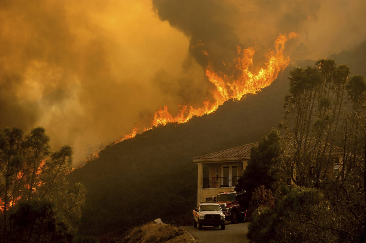 In a Monday, Aug. 17, 2020, file photo, flames from the River Fire crest a ridge in Salinas, Ca ...