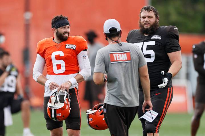 Cleveland Browns quarterback Baker Mayfield (6) and guard Joel Bitonio (75) talk with head coac ...