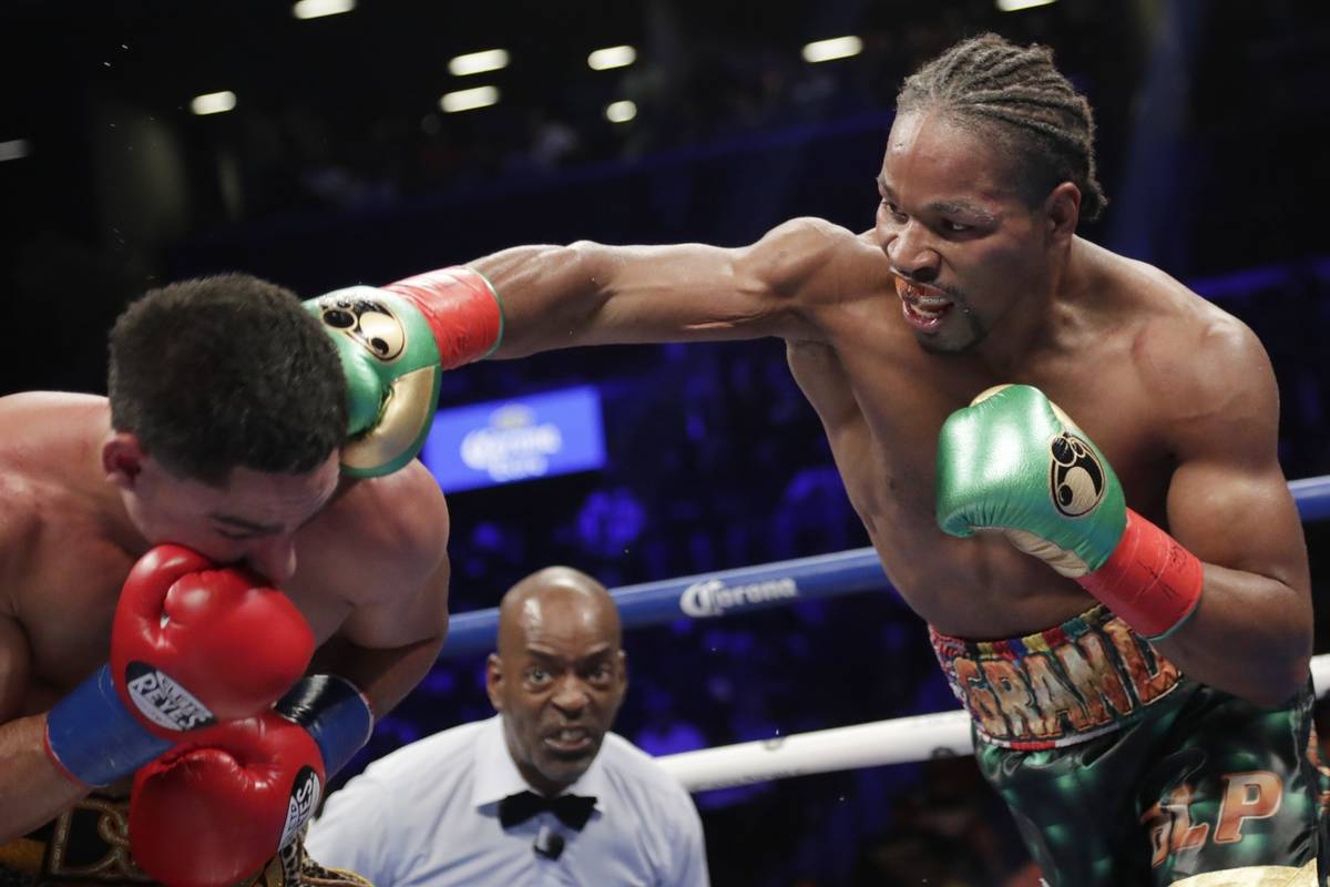 In this Sept. 8, 2018, file photo, Shawn Porter, right, punches Danny Garcia during the eighth ...