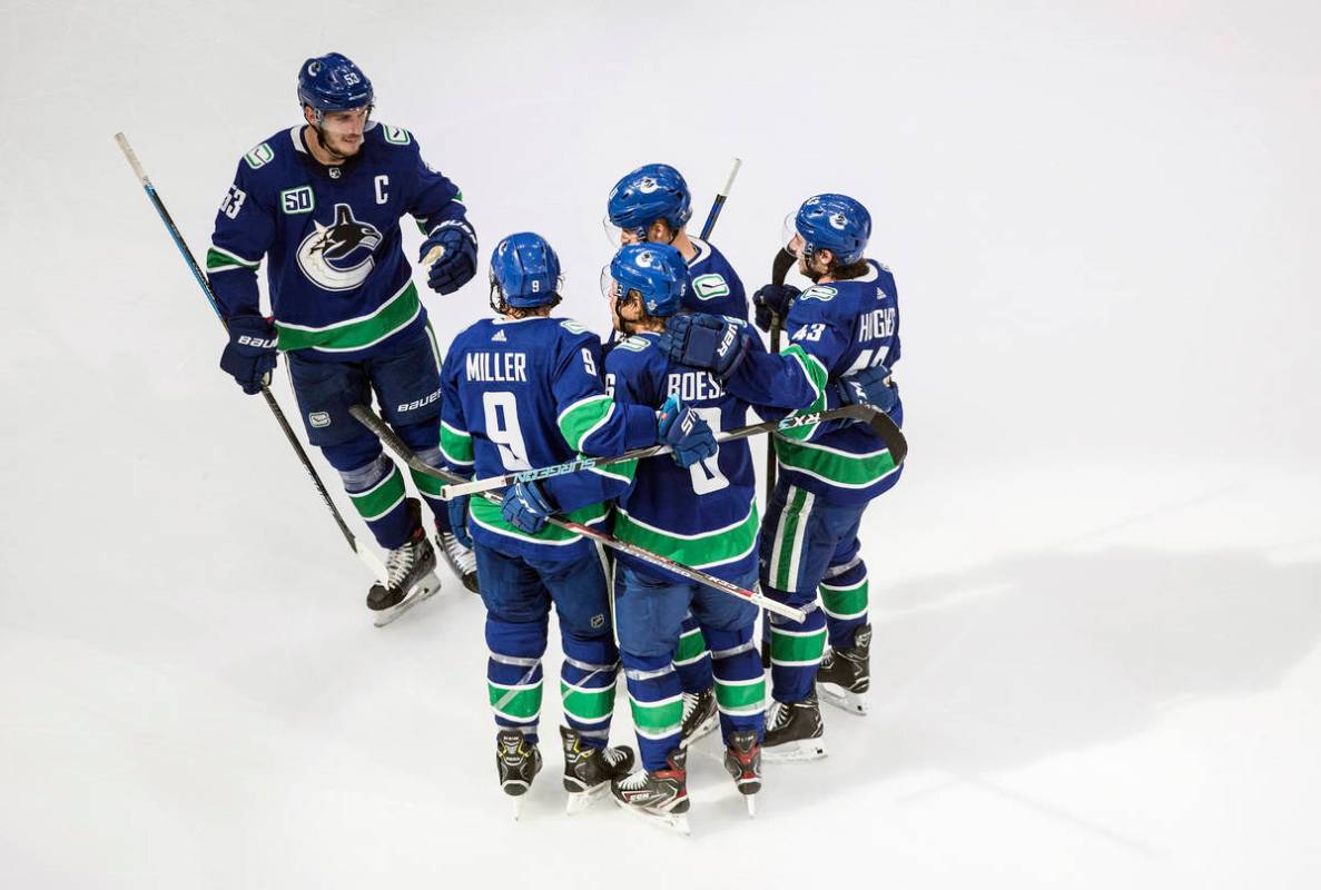 Vancouver Canucks celebrate a goal against the St. Louis Blues during second-period NHL Western ...