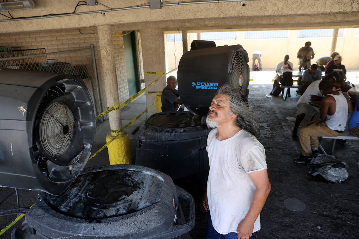 Robert Chavez, 60, stays cool with misters and shade at the Courtyard Homeless Resource Center ...