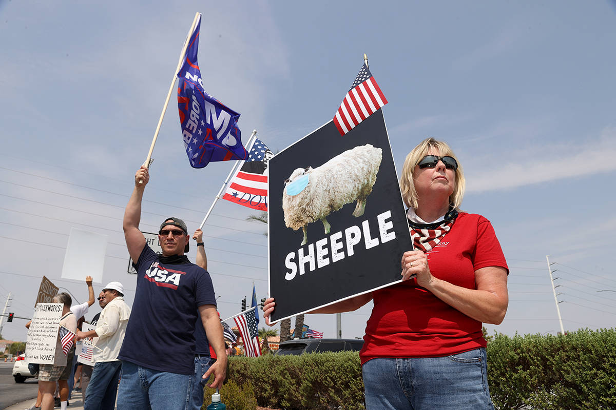 Colene Stevens of Henderson, right, participates during a No Mask Nevada PAC rally at the inter ...