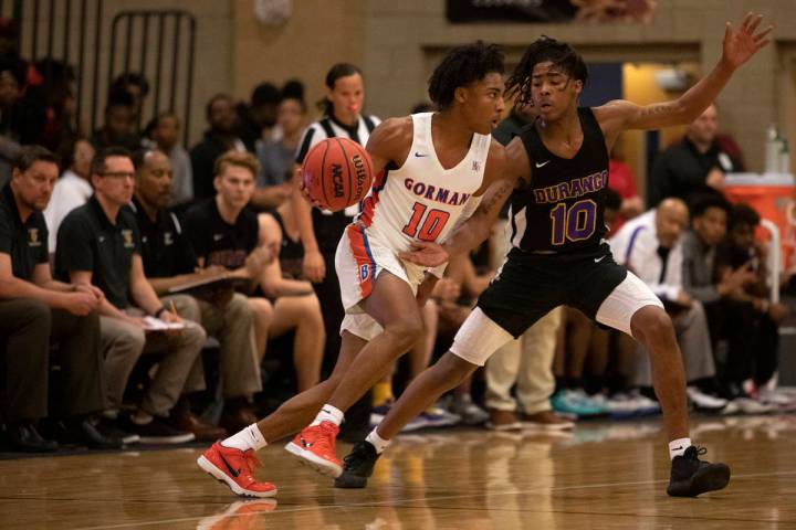 Bishop Gorman's Zaon Collins (10) dribbles past Durango's Keshon Gilbert (10) at Desert Oasis H ...