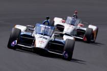 Takuma Sato, of Japan, leads Marco Andretti into turn one during the Indianapolis 500 auto race ...