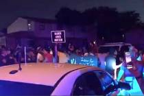 In this image made from video, protesters gather near the site of a police shooting, Sunday, Au ...