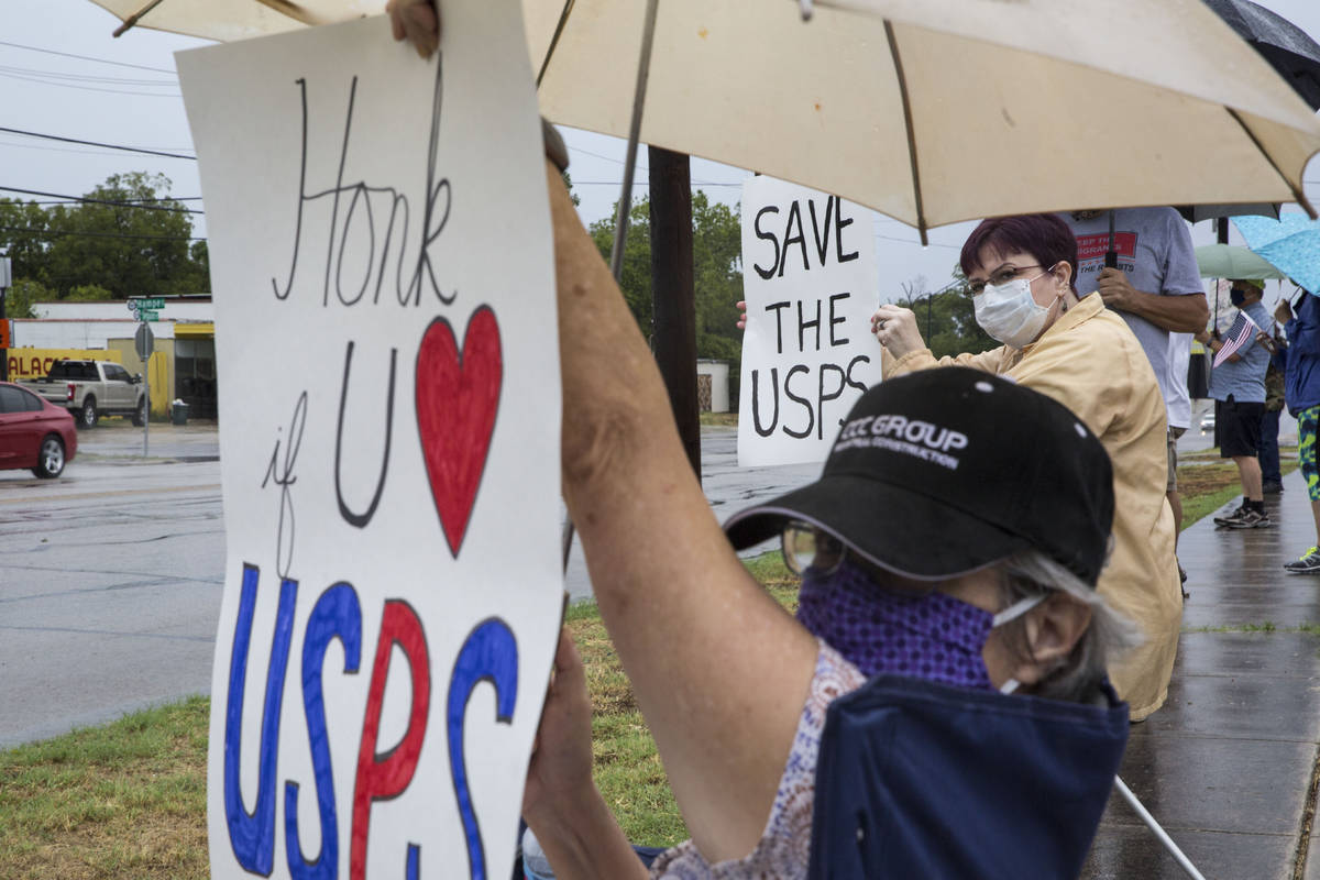 Robin Schriefer and Sue King rally in support of the U.S. Postal Service outside the post offic ...