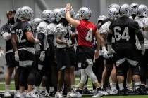 Raiders quarterback Derek Carr (4) leads stretching during NFL football training camp practice ...