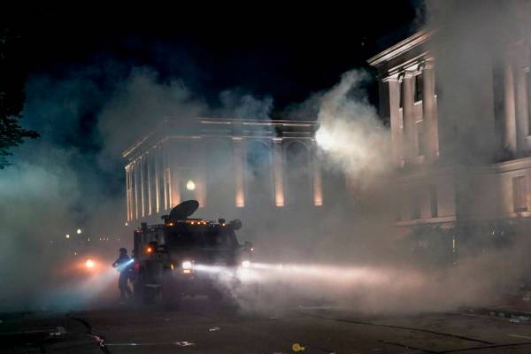 Police clash with protesters near the Kenosha County Courthouse, Monday, Aug. 24, 2020, in Keno ...