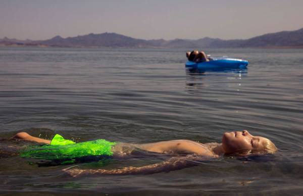 Lucas School, 10, of Glenwood Springs, Colo., floats with his mom Nicole at Boulder Beach about ...