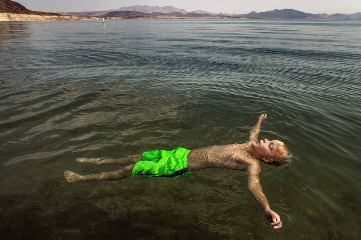 Lucas School, 10, of Glenwood Springs, Colo., floats at Boulder Beach while joining family abou ...