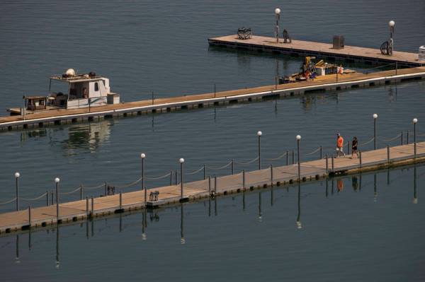 A couple walks along a dock at the Lake Mead Marina about the Lake Mead National Recreation Are ...