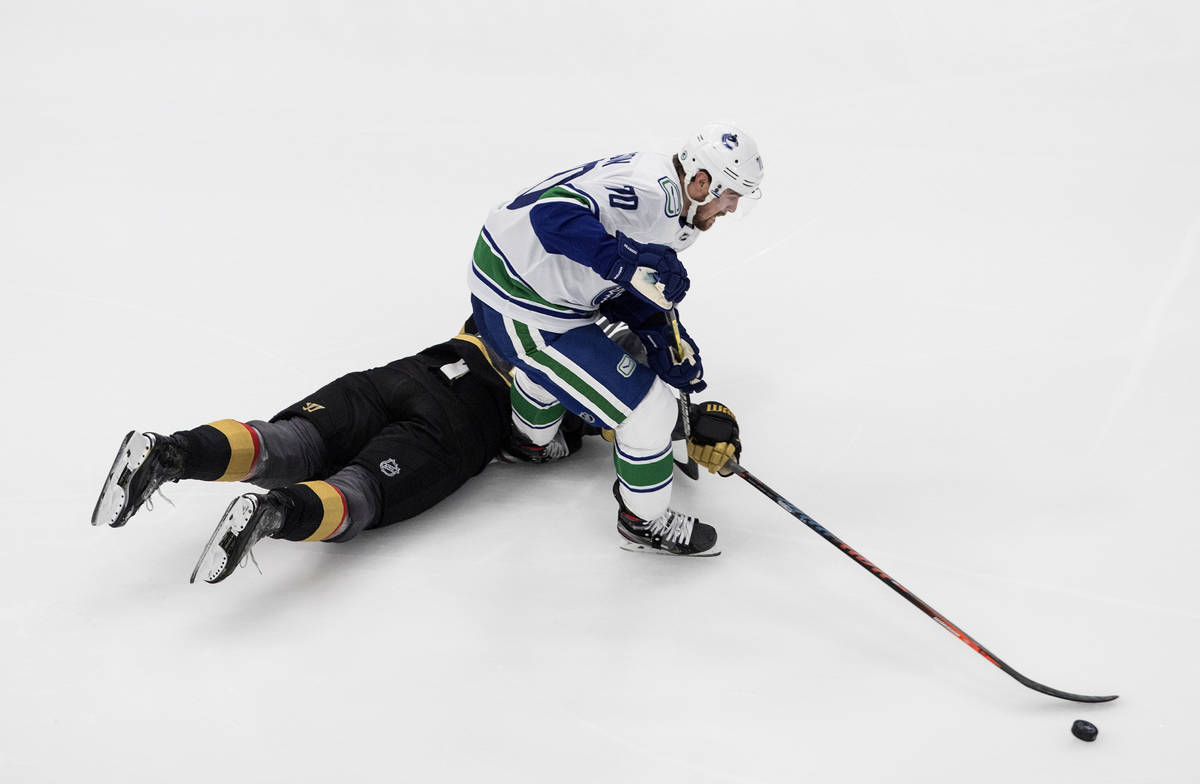 Vegas Golden Knights' Max Pacioretty (67) and Vancouver Canucks' Tanner Pearson (70) battle for ...