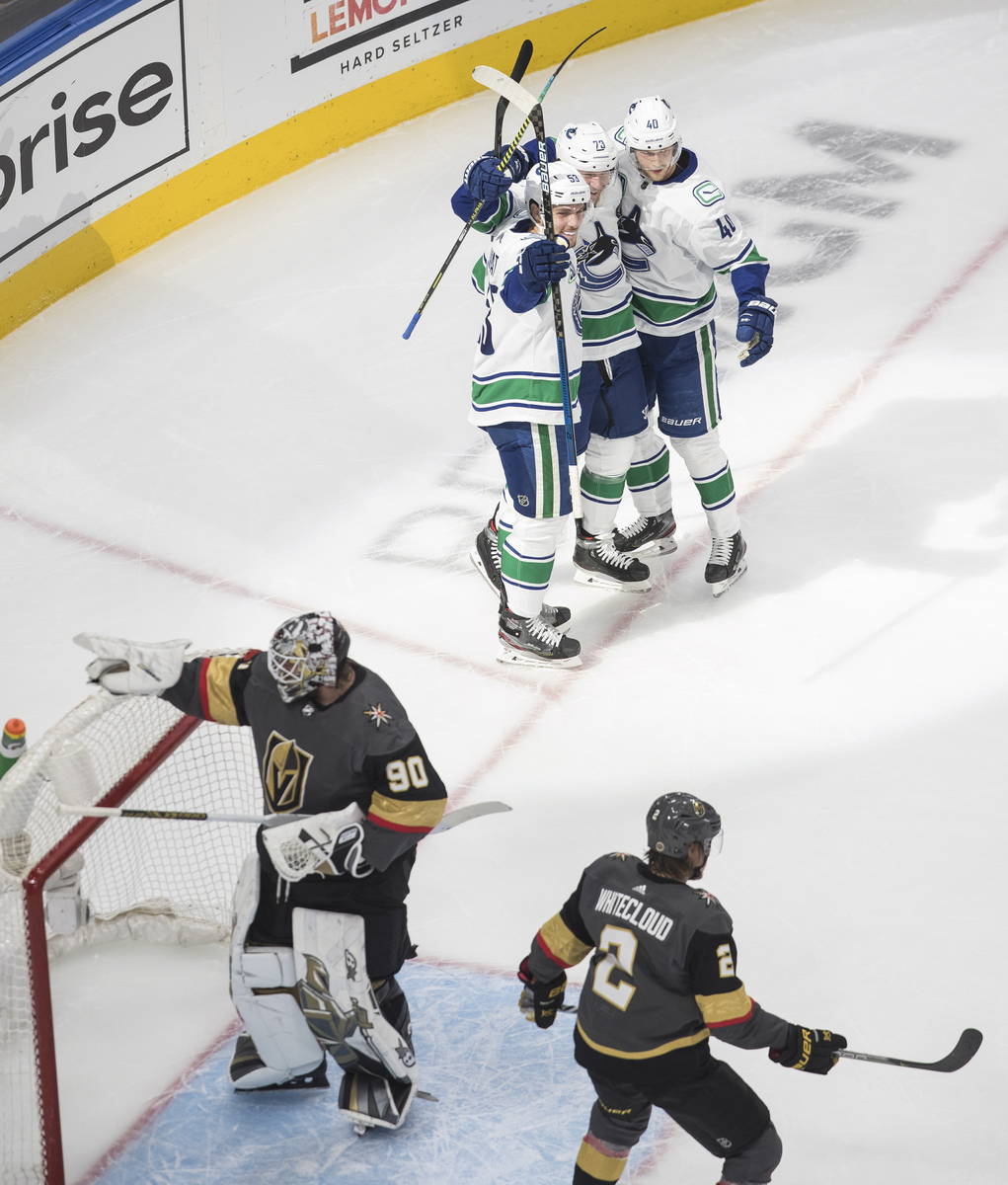 Vancouver Canucks' Bo Horvat (53), Elias Pettersson (40) and Tyler Toffoli (73) celebrate a goa ...