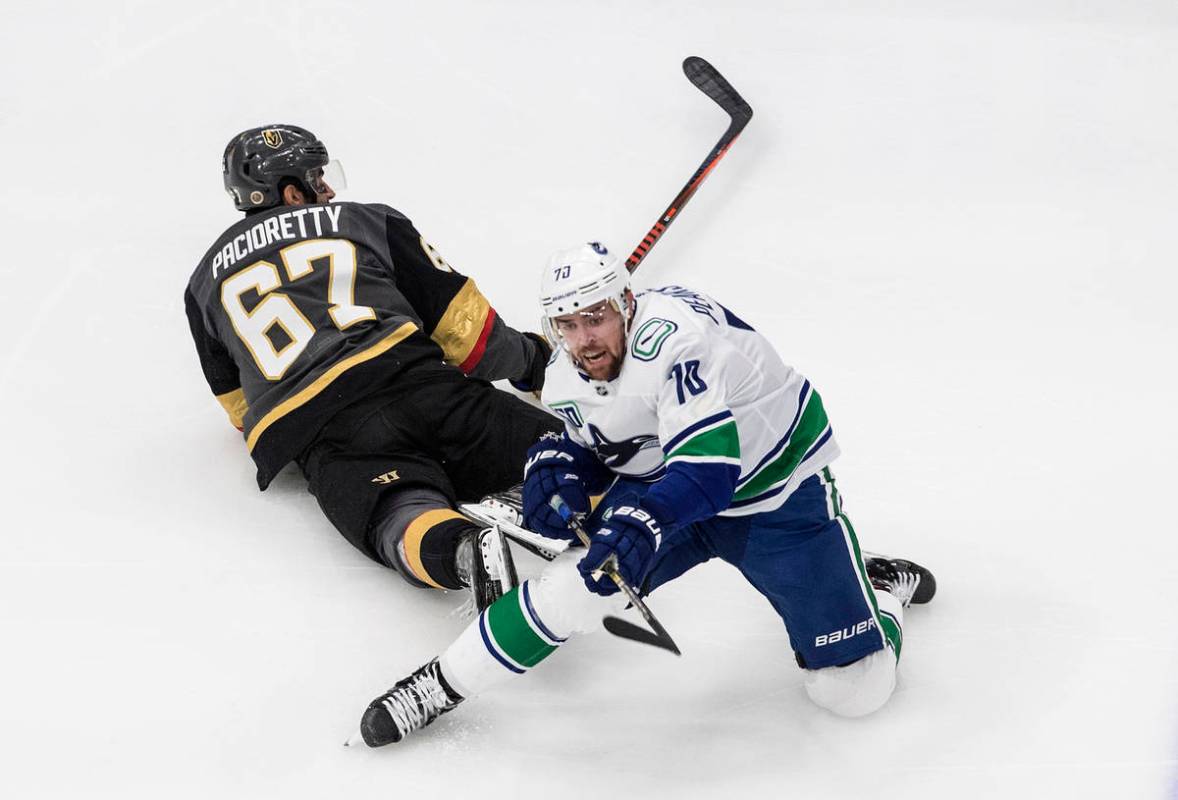Vegas Golden Knights' Max Pacioretty (67) and Vancouver Canucks' Tanner Pearson (70) battle for ...