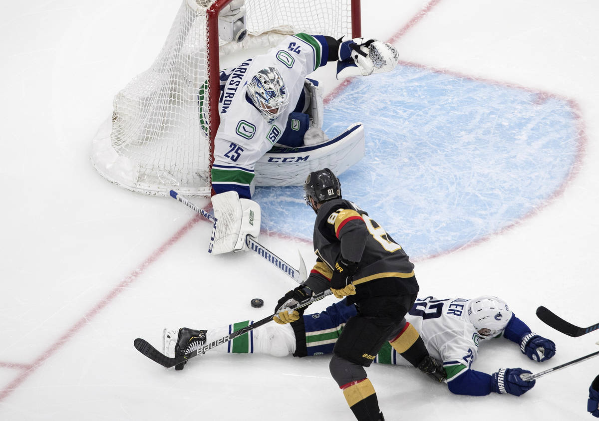 Vegas Golden Knights' Jonathan Marchessault (81) is stopped by Vancouver Canucks goalie Jacob M ...