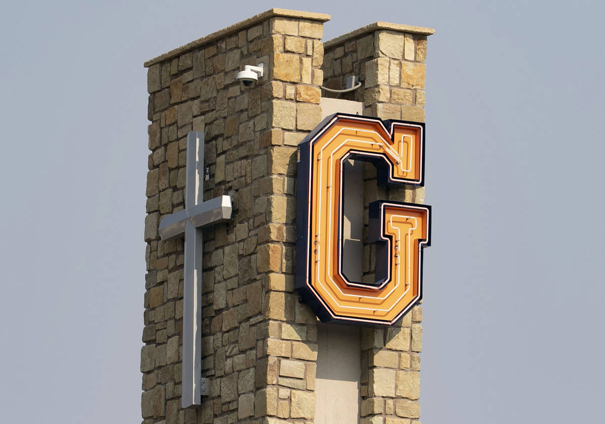 A cross and Bishop Gorman Catholic High School’s logo are photographed on Friday, Aug. 2 ...