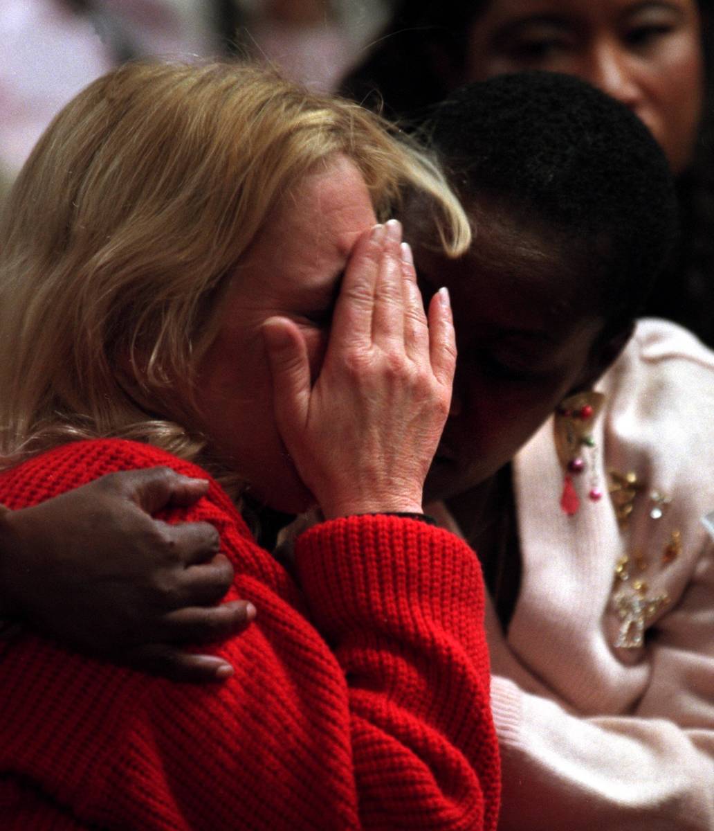 Brigitte Smith, right, comforts Joetta Burke while the prosecution show photos of their childre ...
