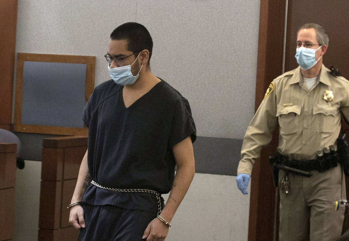 Edgar Samaniego, charged in the shooting of a Las Vegas police officer, is led into the courtro ...