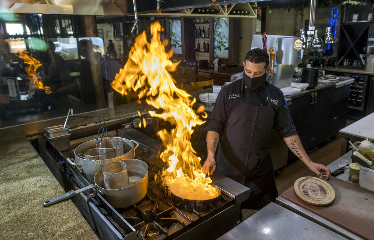 Chef Joe Pierro, Jr., prepares a Saganaki appetizer at the Market Grille Cafe in which they are ...