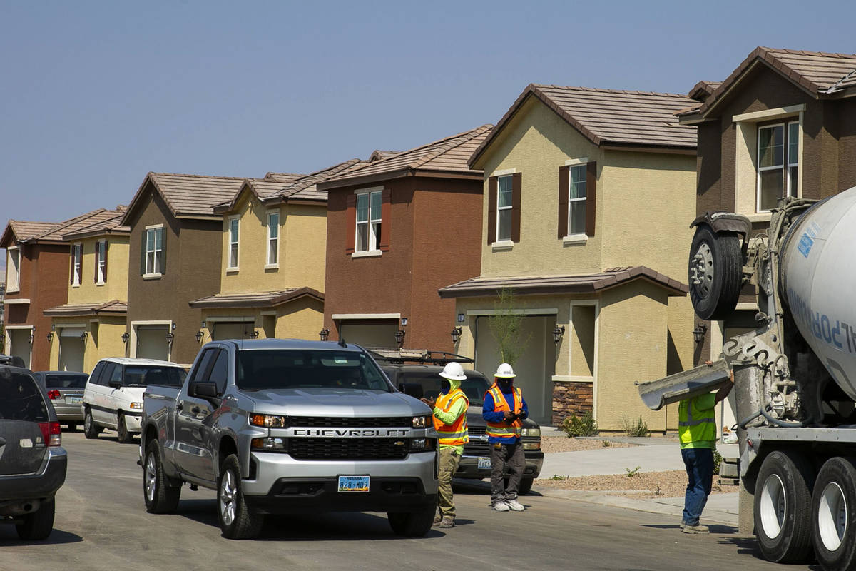 Construction workers are seen at a single-family-housing rental project called Cactus Cliff on ...