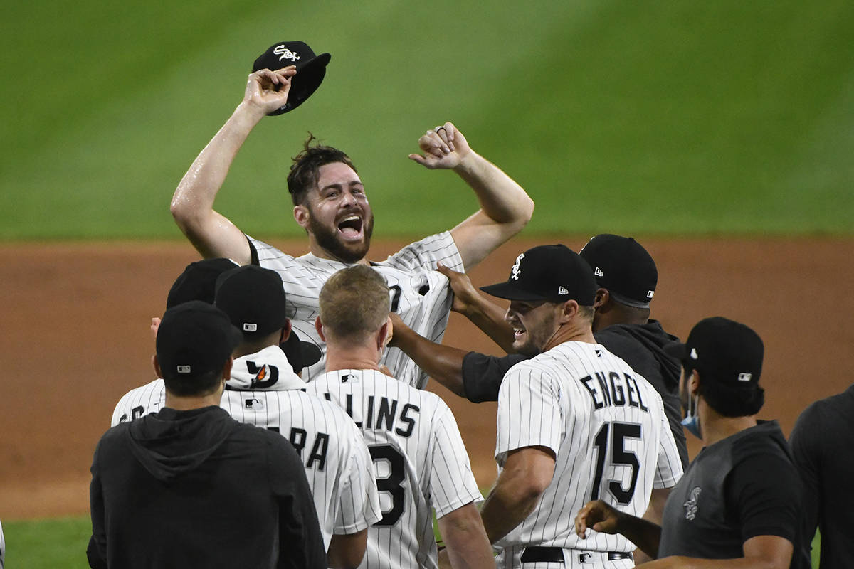 Chicago White Sox starting pitcher Lucas Giolito, facing camera, and teammates celebrate his no ...