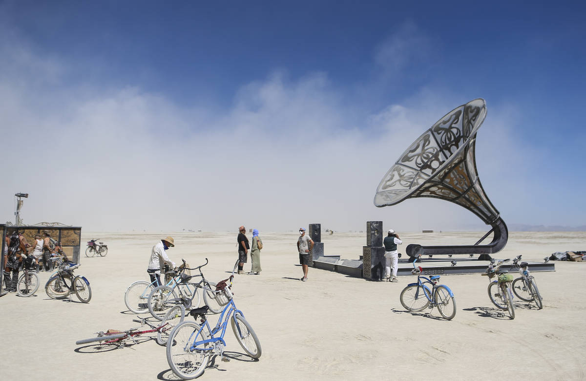 Attendees take in an art installation during Burning Man at the Black Rock Desert north of Reno ...