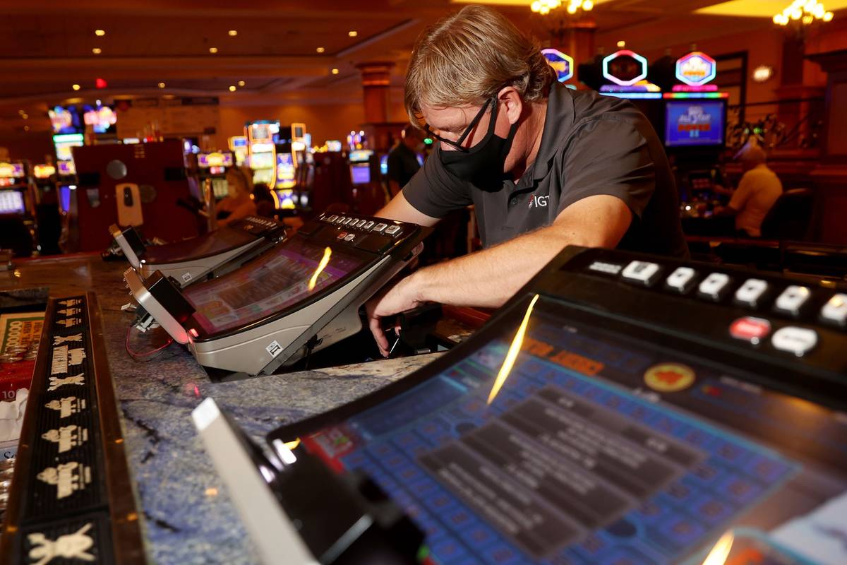 International Game Technology technician Tommy Esposito instalsl PeakBarTop slot machine cabine ...