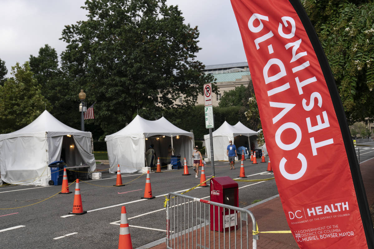 FILE - In this Aug. 14, 2020, file photo, members with the Washington, D.C. Dept. of Health, ad ...