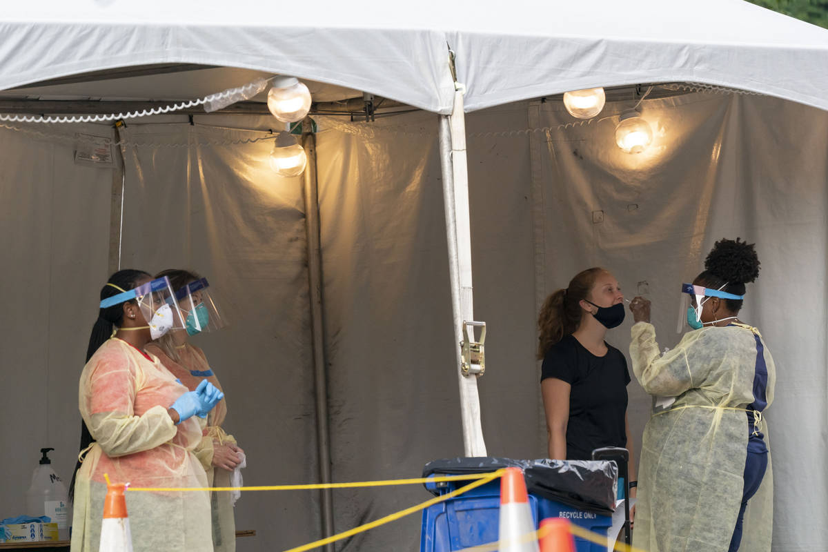 FILE - In this Aug. 14, 2020, file photo, a nurse with the Washington, D.C. Dept. of Health, ad ...