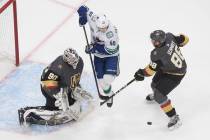 Vegas Golden Knights' goalie Robin Lehner (90) makes the save as Vancouver Canucks Elias Petter ...