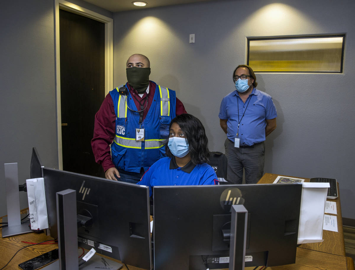 Jessica Brown, front, monitors the numerous RTC camera feeds within the control center at the B ...