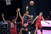 Dallas Wings forward Satou Sabally passes the ball in front of Las Vegas Aces forward Angel McC ...