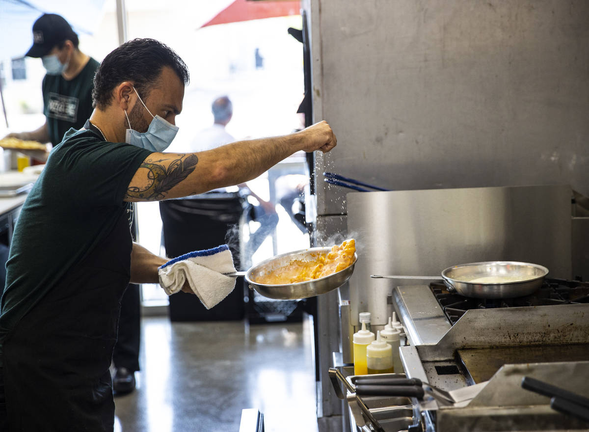 Mimmo Ferraro, owner and chef at Pizza Forte, right, prepares rigatoni with vodka pink sauce in ...