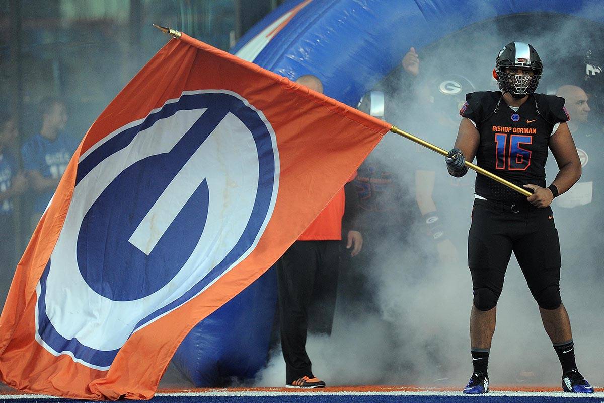 Bishop Gorman defensive lineman Haskell Garrett waves his team's flag before the start of their ...