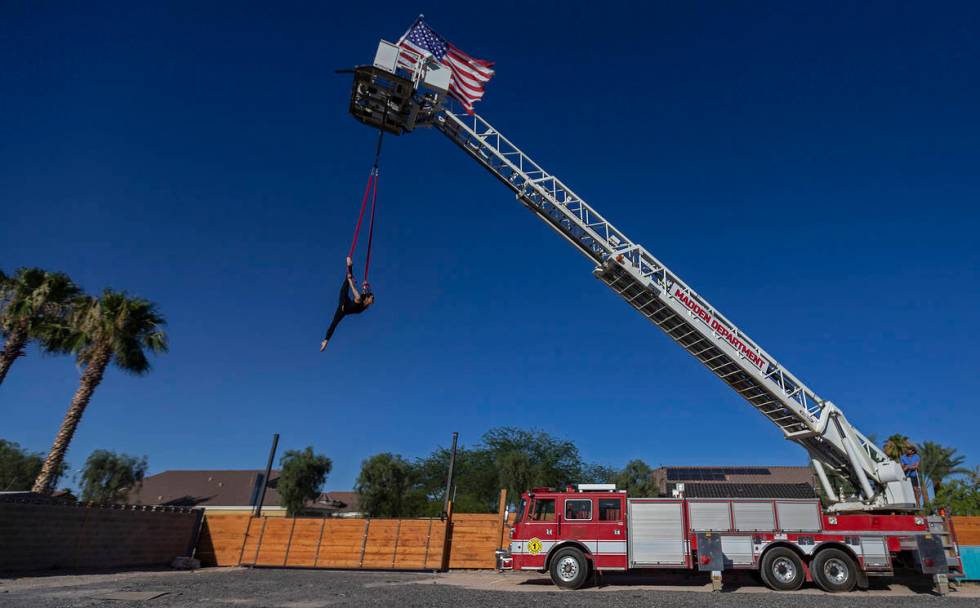 Elema Sanders practices on aerial straps attached to an out-of-service fire truck at the home o ...