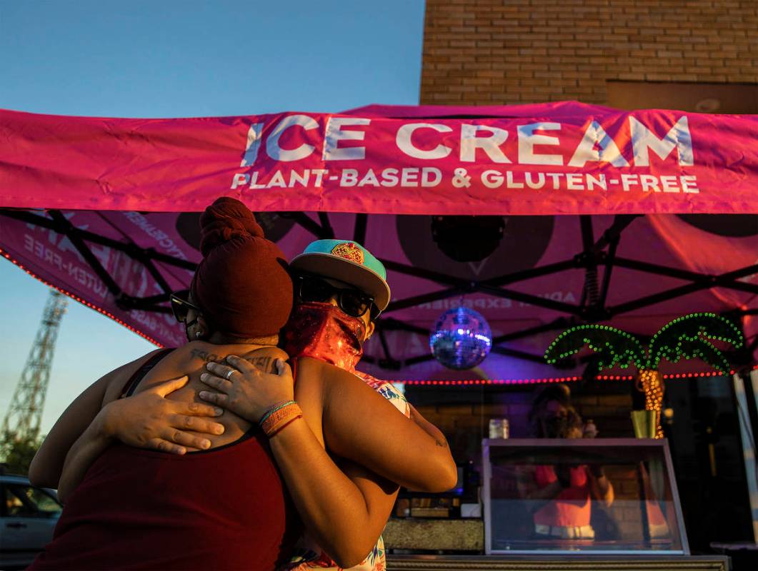 Production manager Angie Ortaliza, right, hugs a customer at Paradise City Creamery on Friday, ...