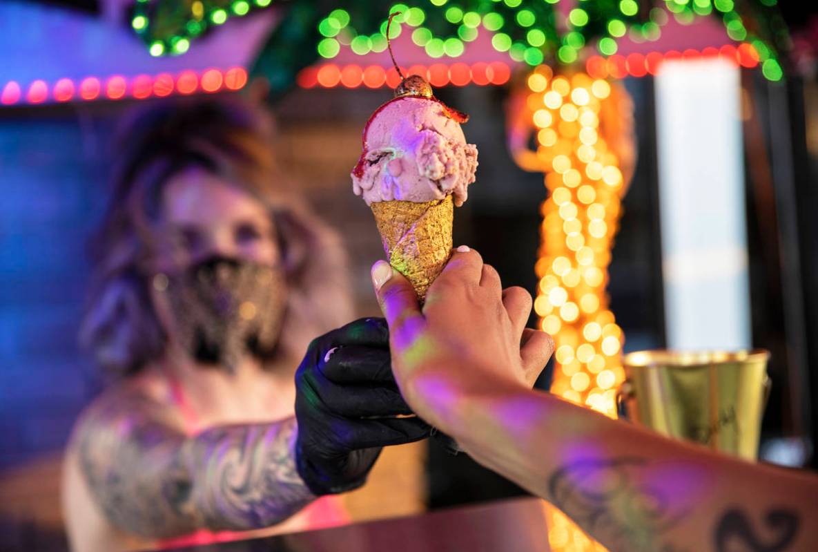 Founder and head creamstress Valerie Stunning hands an ice cream cone called "Baby Stripper" to ...