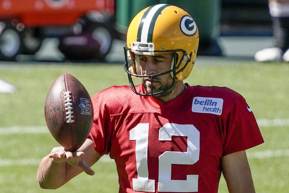 Green Bay Packers' Aaron Rodgers plays with a football during NFL football practice Friday, Sep ...