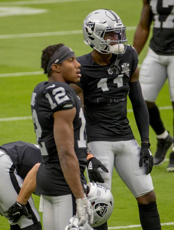 Las Vegas Raiders wide receiver Henry Ruggs III (11, right) stands with teammate Las Vegas Raid ...