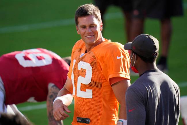 Tampa Bay Buccaneers quarterback Tom Brady (12) talks to a coach during an NFL football trainin ...