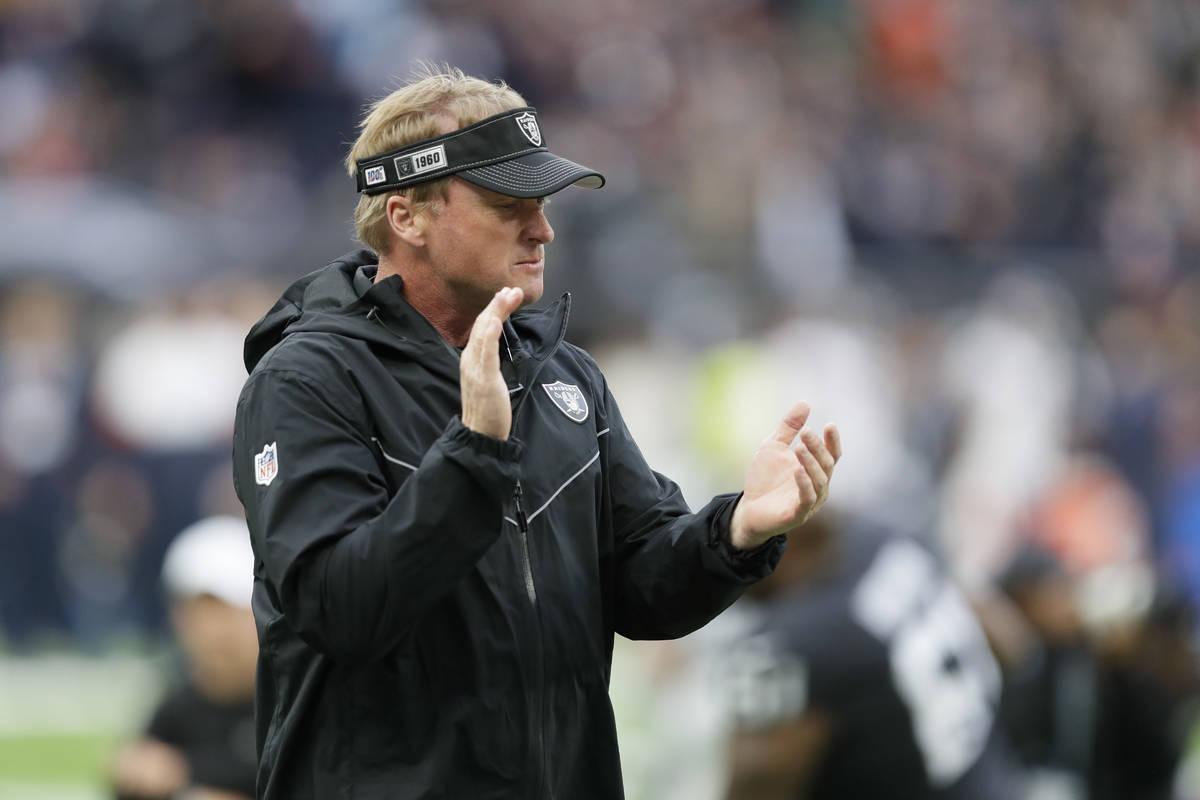 Oakland Raiders head coach Jon Gruden encourages his team as they prepare for an NFL football g ...